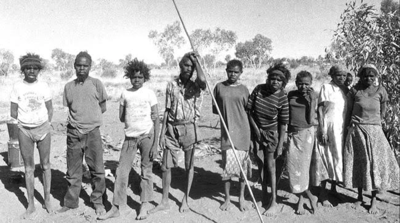 A black and white photo of the family group when they walked out of the desert in 1984. The family group was among the last Aboriginal people to come into contact with Western society. 