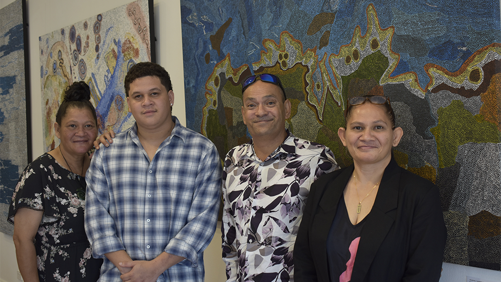 Contemporary Aboriginal Artists Helen McCarthy Tyalmuty, Heath Minjin Wilson, Allen Stephensen and Kerry Madawyn McCarthy standing their their artworks