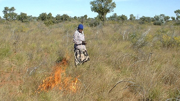 Lorna Fencer on Country performing grass burning