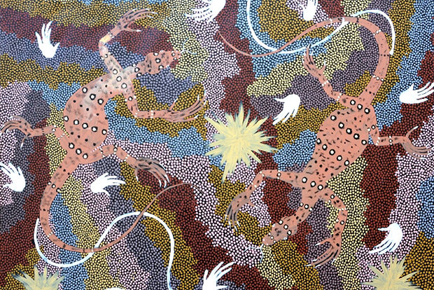 Artwork by Clifford Possum depicting two goannas on a dotted background. Tracks left by the tail and claws can also be seen.