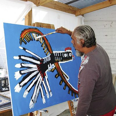 Trevor Turbo Brown painting one of his animals in a naive style